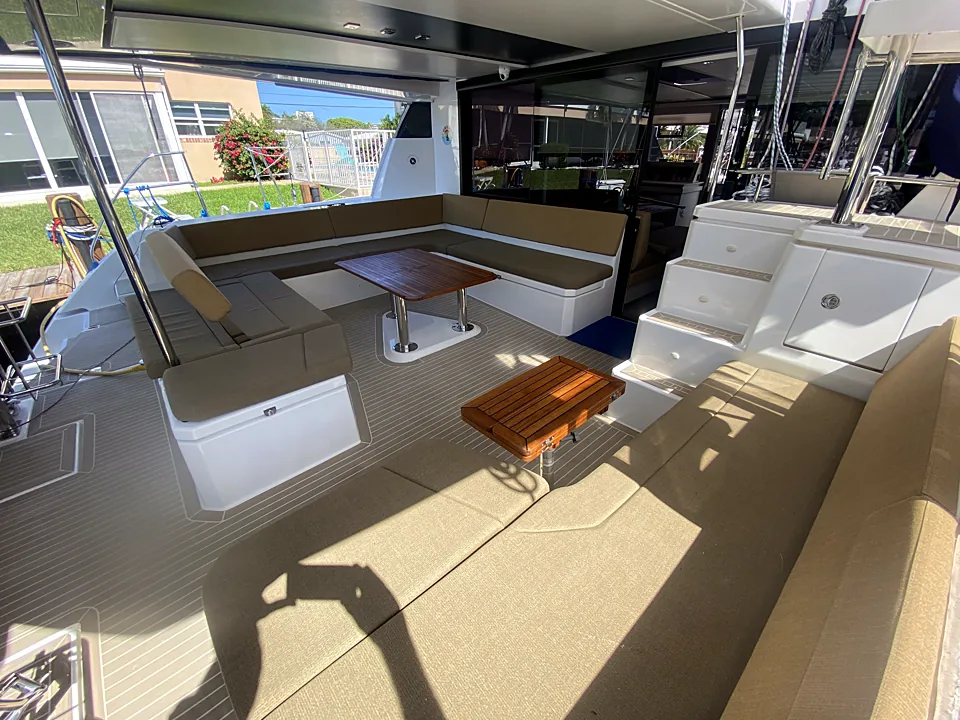 Aft cockpit lounge with wraparound seating and teak tables