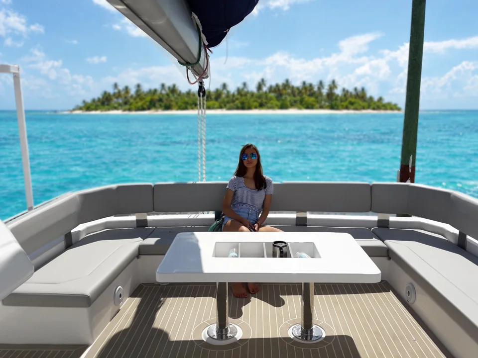 Drina relaxing in the flybridge lounge, a palm island on the horizon